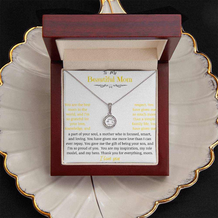 A white gold eternal hope necklace close up in a mahogany box on a coffee filter