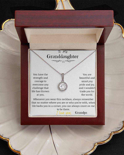 a white gold eternal hope necklace up close in a mahogany box on a coffee filter