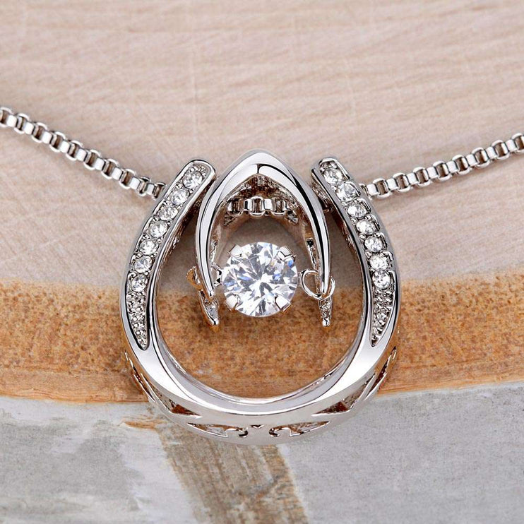 lucky in love necklace up close of charm on a stump
