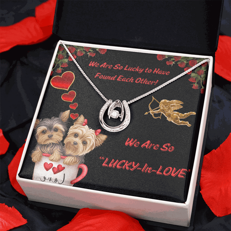 lucky in love necklace in a soft box on a bed of red rose petals