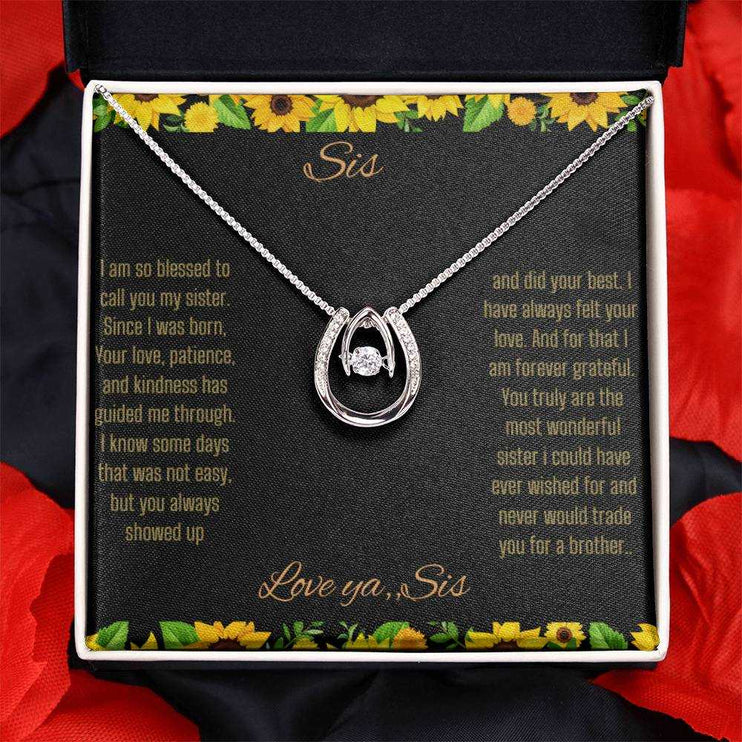Lucky In Love Necklace with a white gold charm on a To Sis From Sis greeting card inside a two-tone box