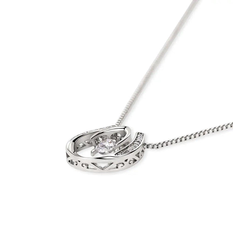 white gold lucky in love necklace laying on side