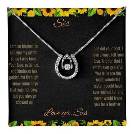 Lucky In Love Necklace with a white gold charm on a To Sis From Sis greeting card up close view