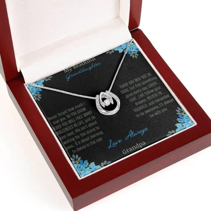 Lucky In Love Necklace with a white gold charm on a to granddaughter from grandpa greeting card in a mahogany box angled to the right 