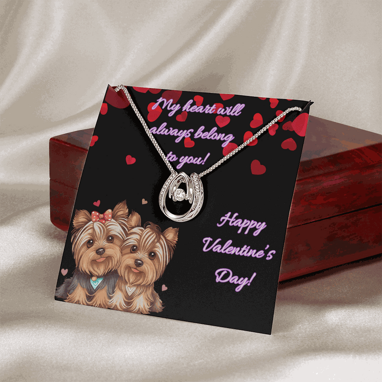 lucky in love necklace on a greeting card leaning on a closed mahogany box birds eye view