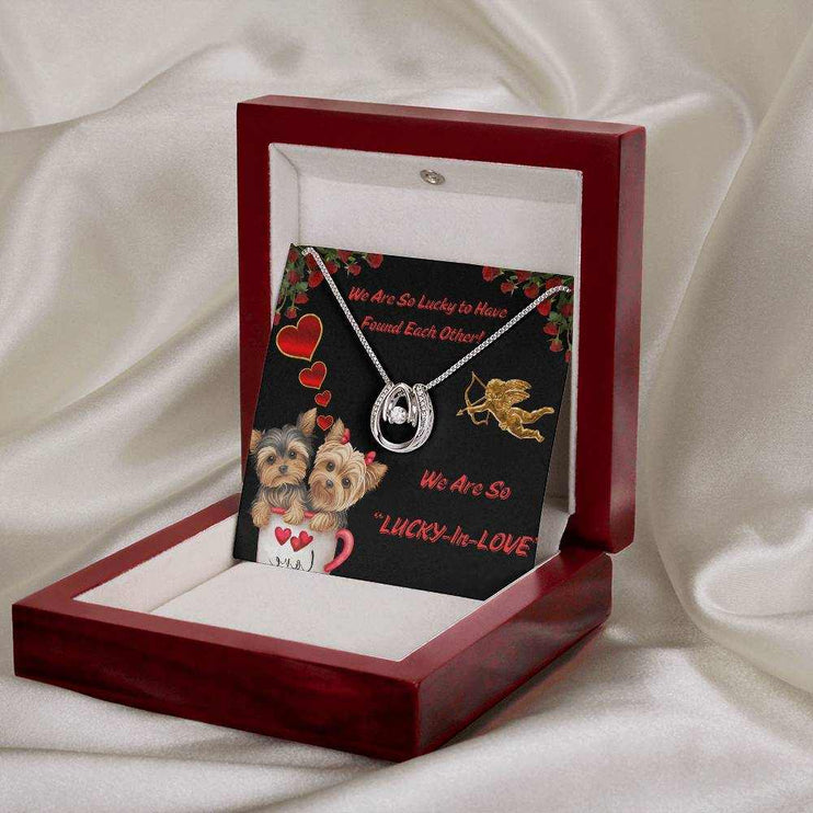 lucky in love necklace on a message card tilted up in a luxury box