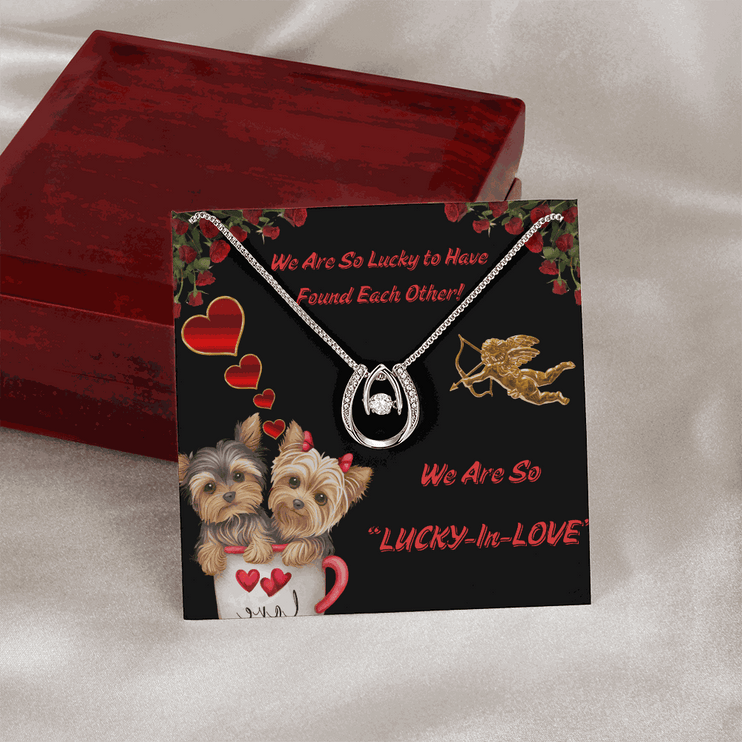 lucky in love necklace outside of a closed luxury box on a card