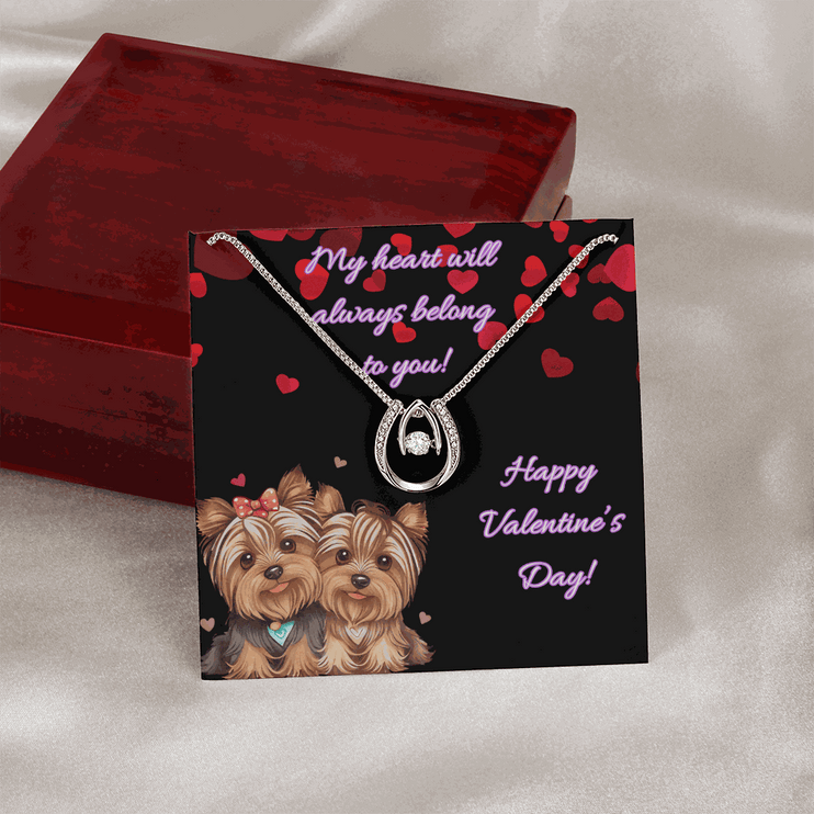 lucky in love necklace on a greeting card leaning on a closed mahogany box up close