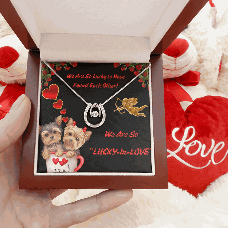 lucky in love necklace in a luxury box in a model's hand