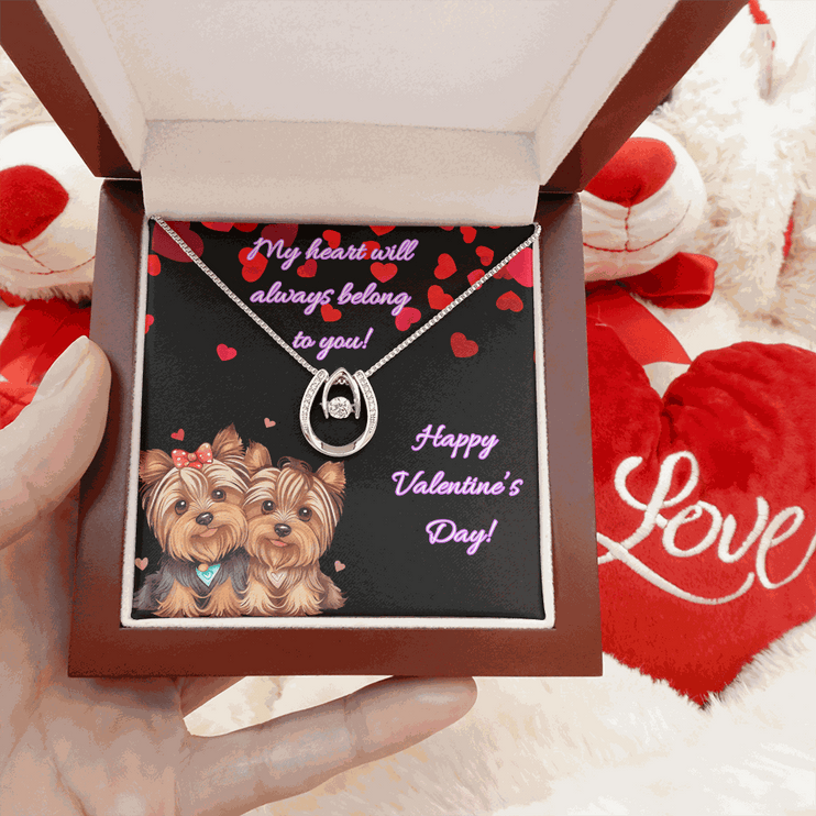 lucky in love necklace in a mahogany box with red heart pillows