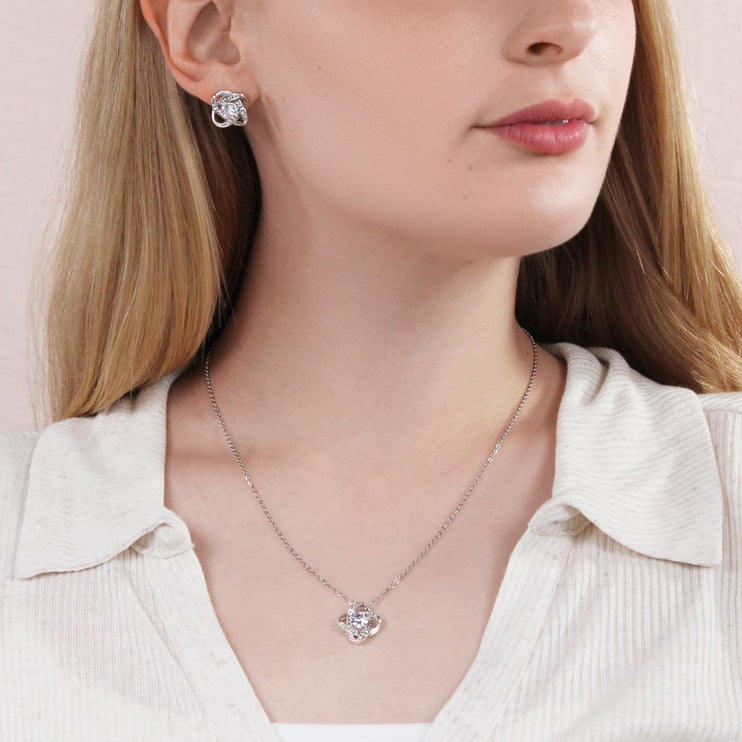 Love Knot Necklace Love Knot Earring Set with a white gold pendant on a model