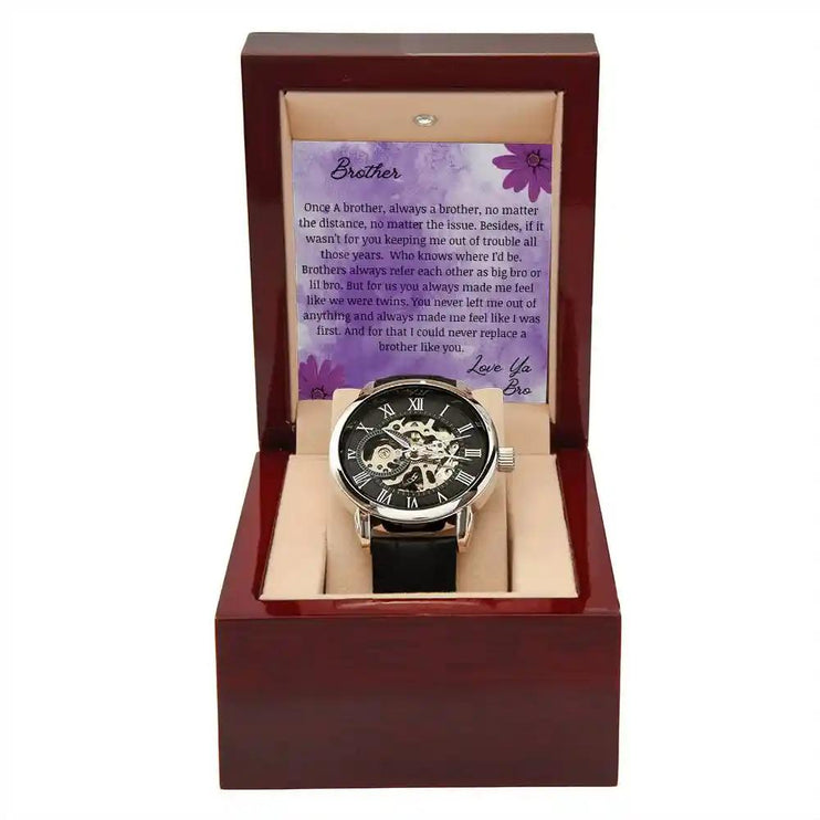 A men's openwork watch and a to brother greeting card in a mahogany box.