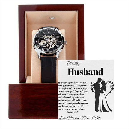 openwork watch in a mahogany box with greeting card leaning on box