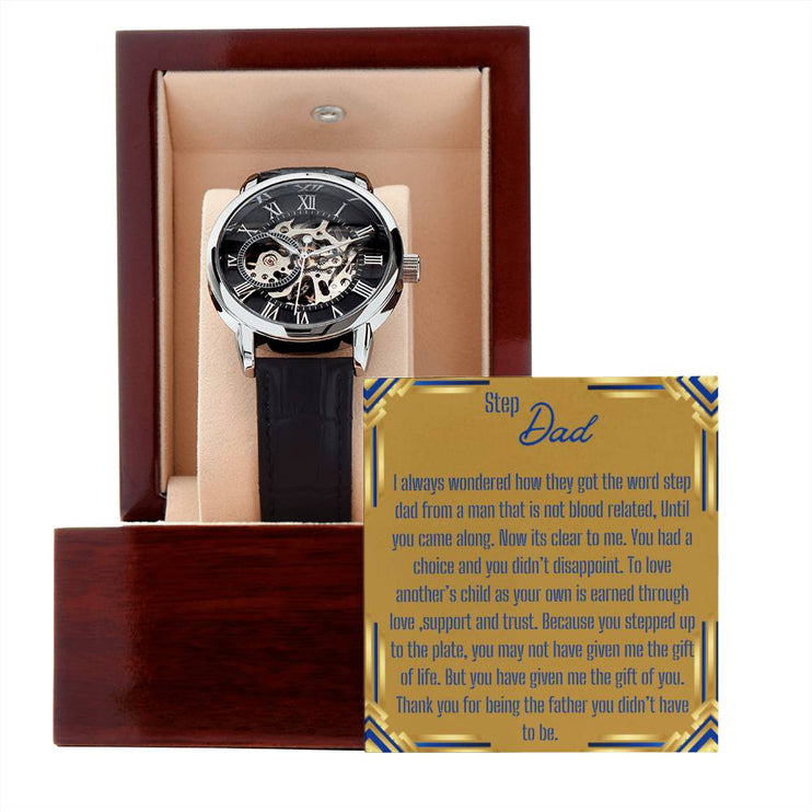 a men's openwork watch in a mahogany box with to stepdad greeting outside of box.