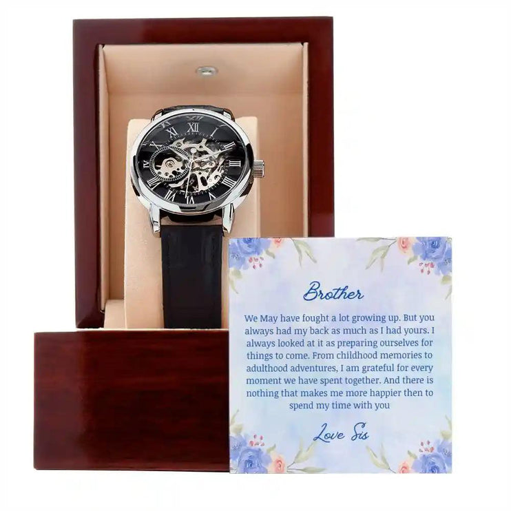 A Men's Open work Watch and to brother greeting card outside of a mahogany box.