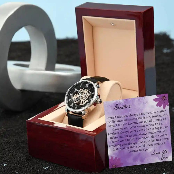 A Men's Openwork Watch in a mahogany box angled to the right with a to brother card leaning on the box.
