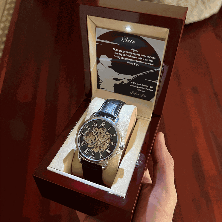 openwork watch in a mahogany box in a model's hand