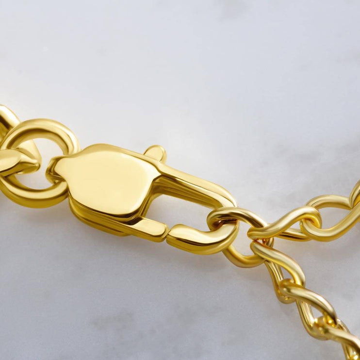 yellow gold Cuban link chain up close of clasp