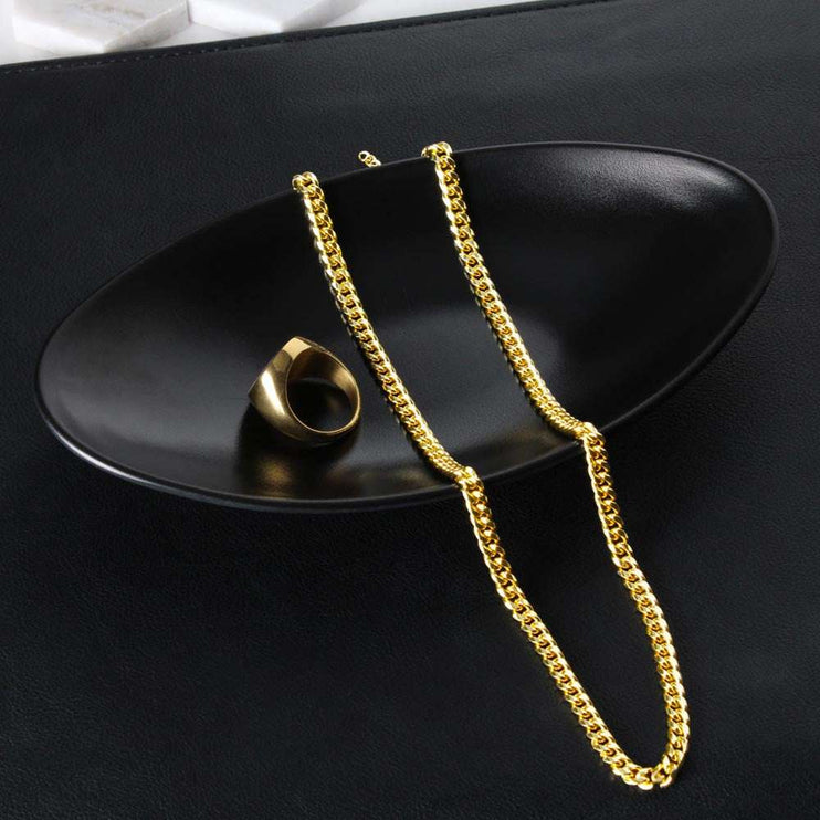 yellow gold Cuban link chain on a black display