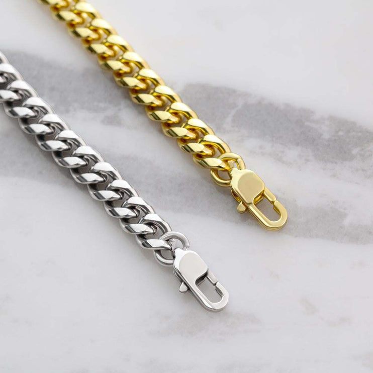yellow gold and stainless-steel Cuban link chain lobster clasps up close
