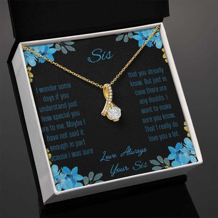 Alluring Beauty Necklace with a yellow gold variant on a to sis from sis greeting card inside a two-tone box angled slightly to the left with a close up view.