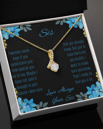 Alluring Beauty Necklace with a yellow gold variant on a to sis from sis greeting card inside a two-tone box angled slightly to the left with a close up view.