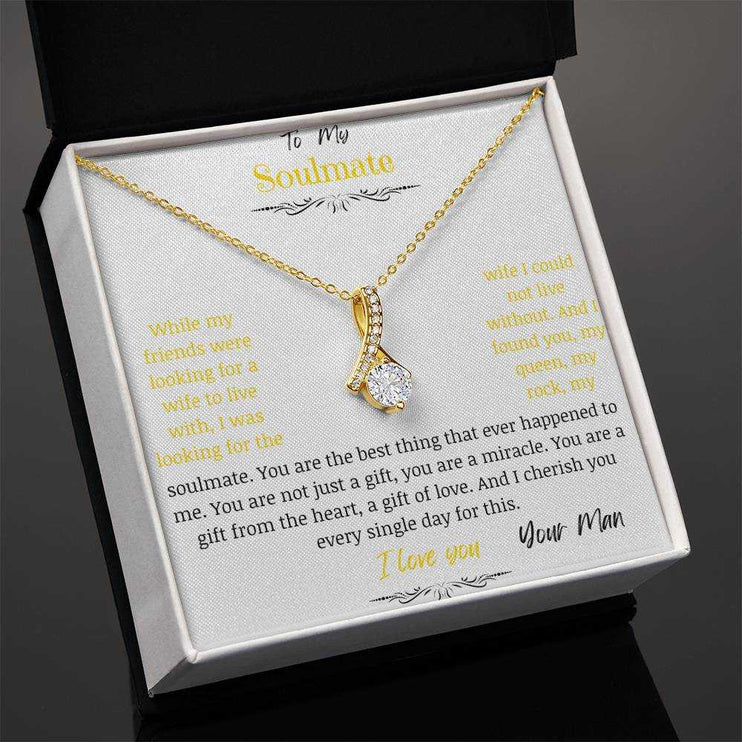 A yellow gold alluring beauty necklace in a two-tone box on a angle.