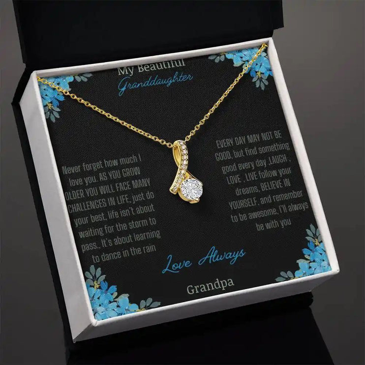 Alluring Beauty Necklace with a yellow gold charm with a to granddaughter from grandpa greeting card in a two-tone box angled slightly to right