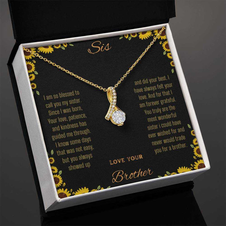 Alluring Beauty Necklace with a yellow gold variant on a To Sis from Brother greeting card in a two-tone box angled slightly to the left with a close up view