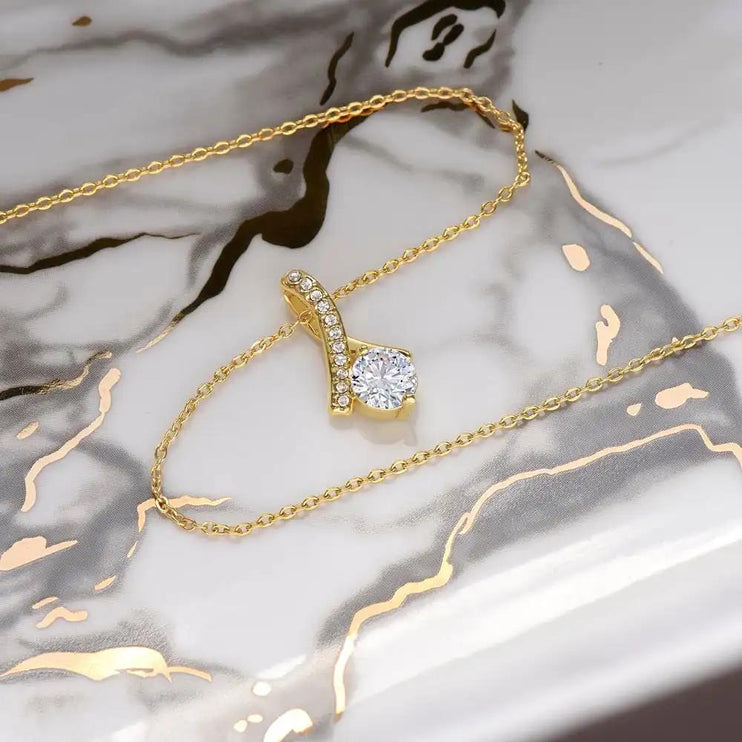 yellow gold alluring beauty necklace on a table