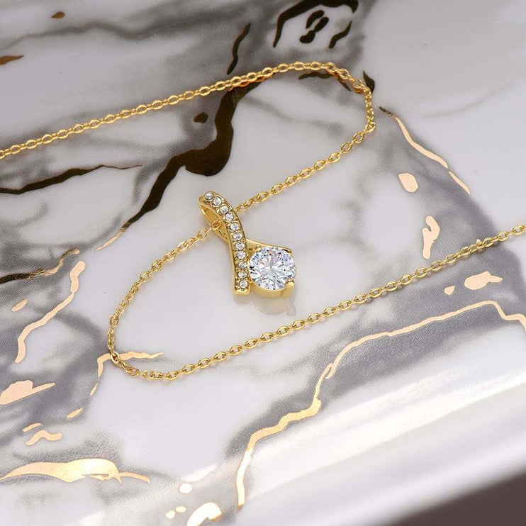 yellow gold alluring beauty necklace on a white marble top