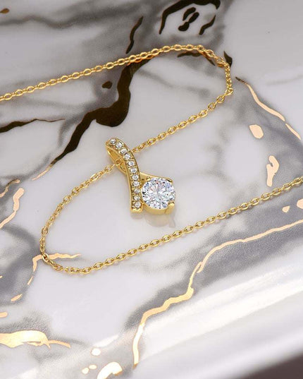 yellow gold alluring beauty necklace on a marble top