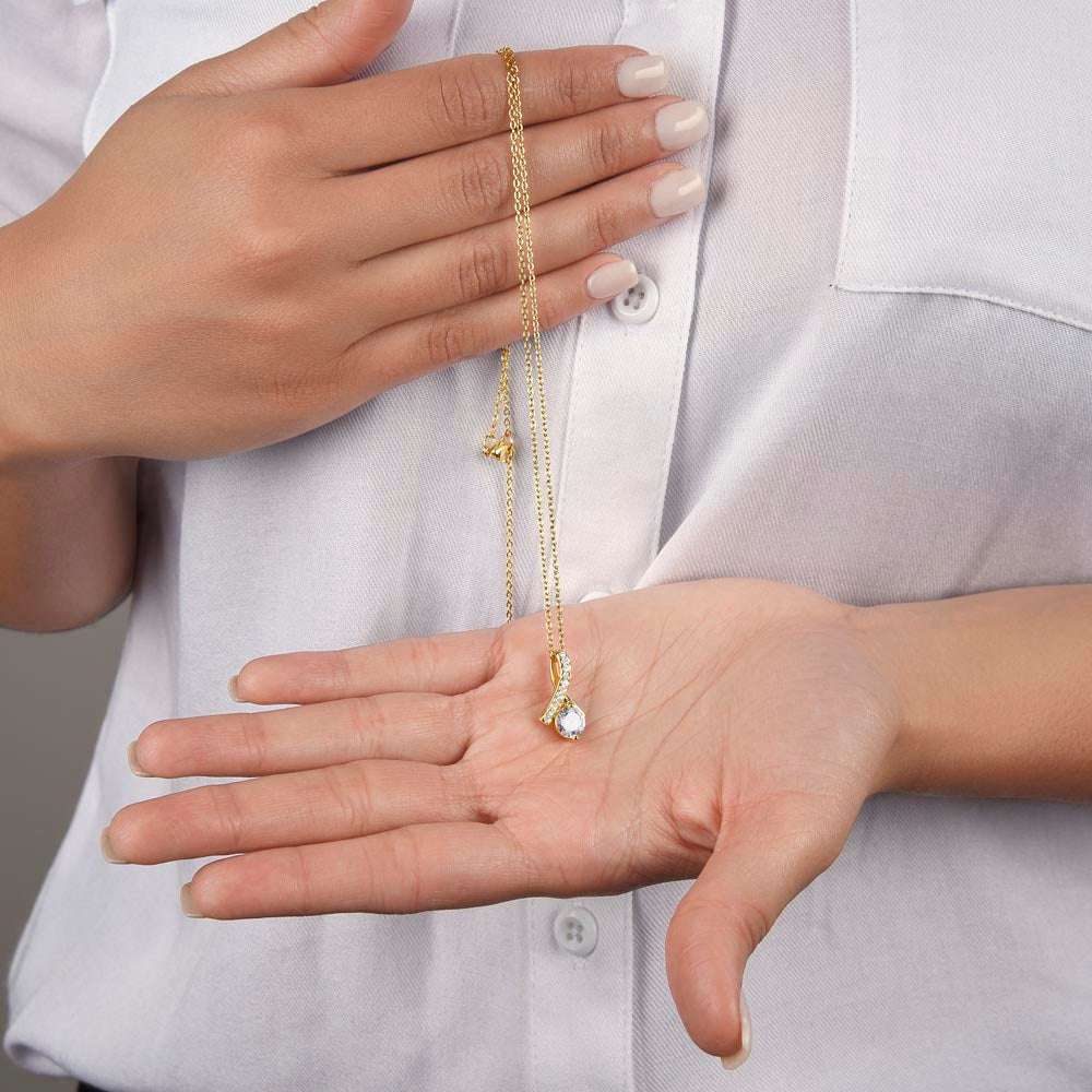 yellow gold alluring beauty necklace in a model's hand