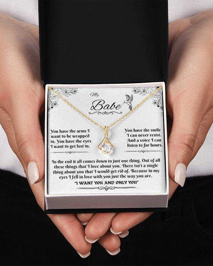 yellow gold alluring beauty necklace in a soft box in model's hands
