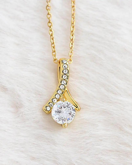 yellow gold alluring beauty necklace on a white fleece