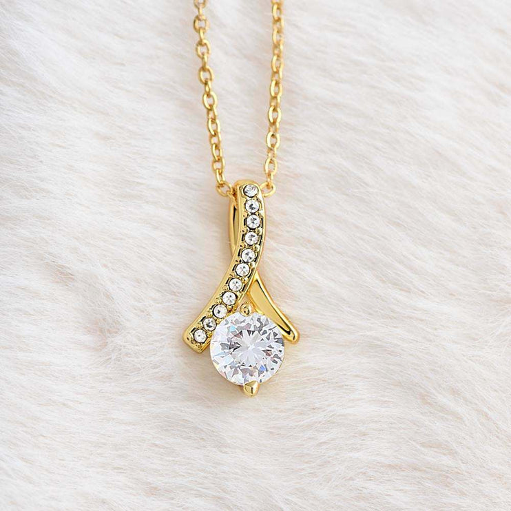 yellow gold alluring beauty necklace on a white felt cloth