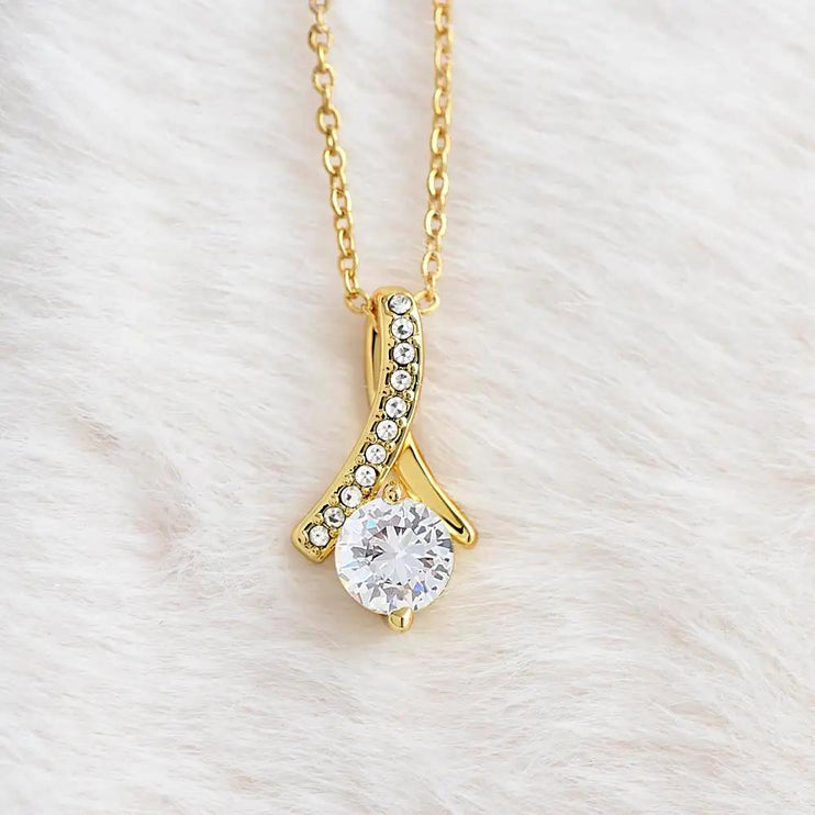 yellow gold alluring beauty necklace on a white fleece