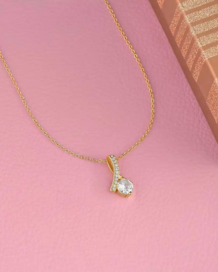 yellow gold alluring beauty necklace on pink table