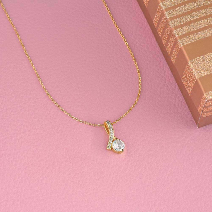 yellow gold alluring beauty necklace on pink cloth