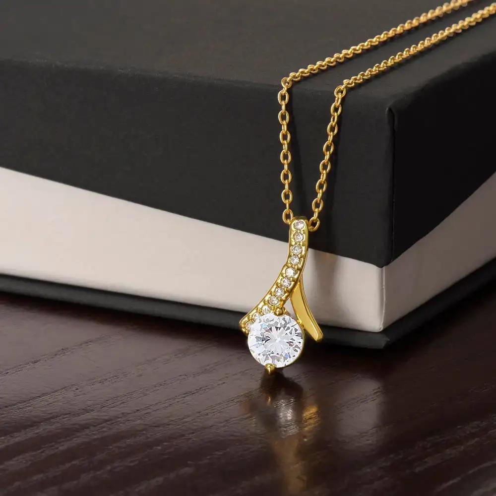 yellow gold alluring beauty necklace on top of two-tone box