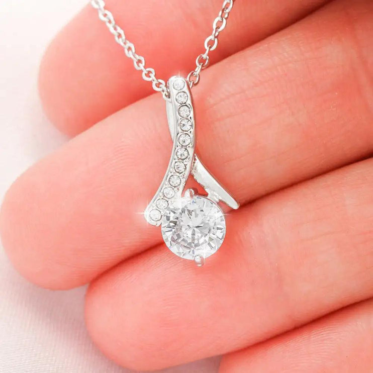 white gold alluring beauty necklace in a models hand