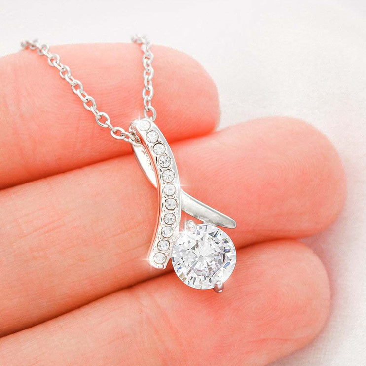 white gold alluring beauty necklace in a model's hand