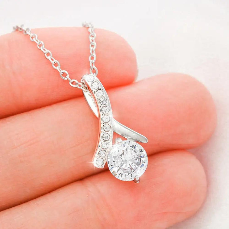 white gold alluring beauty necklace in model's hand