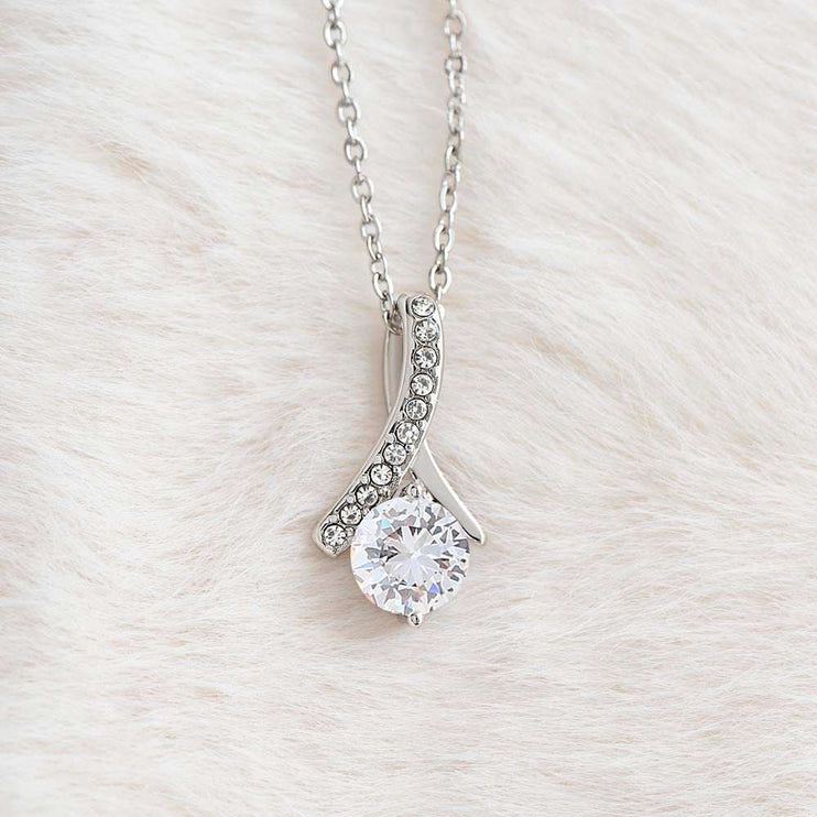 white gold alluring beauty necklace on a white felt cloth 