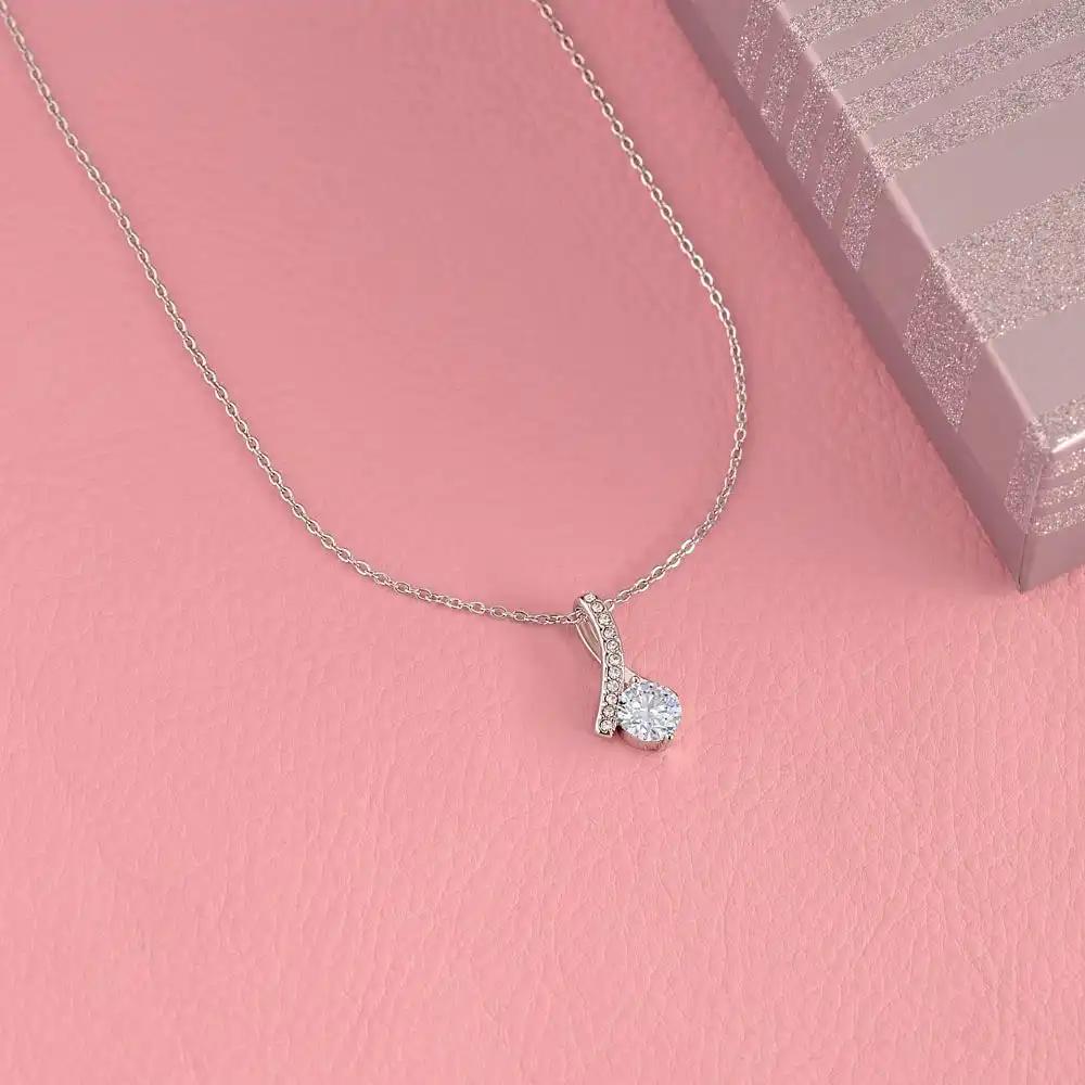 white gold alluring beauty necklace on pink table