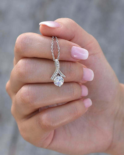 white gold alluring beauty necklace in a model's hand