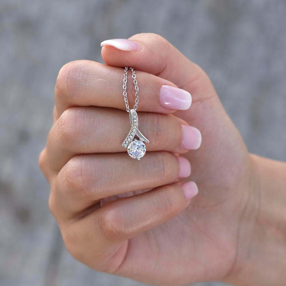 white gold alluring beauty necklace in a model's hand