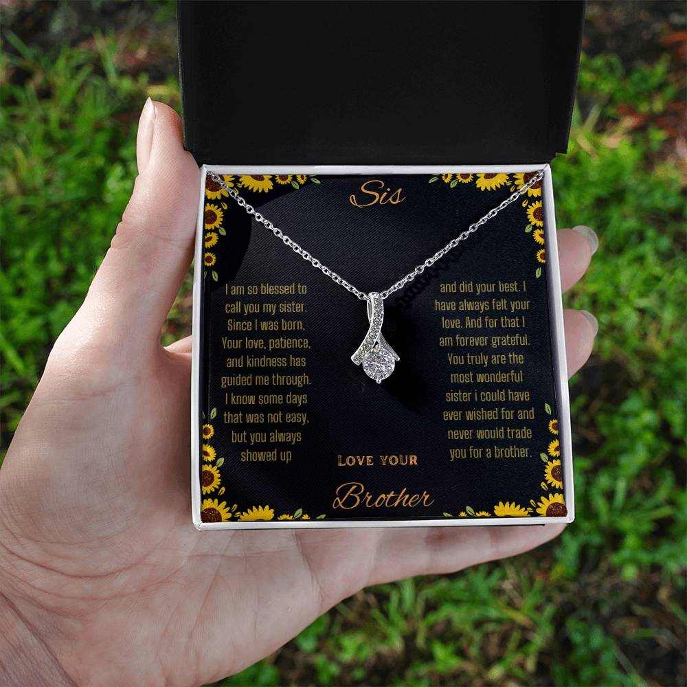 Alluring Beauty Necklace with a white gold variant on a To Sis from Brother greeting card inside a two-tone close up view