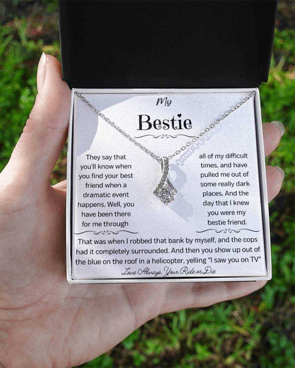 a white gold alluring beauty necklace in a models hand
