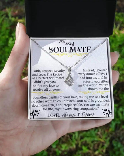 a white gold alluring beauty necklace in a models hands